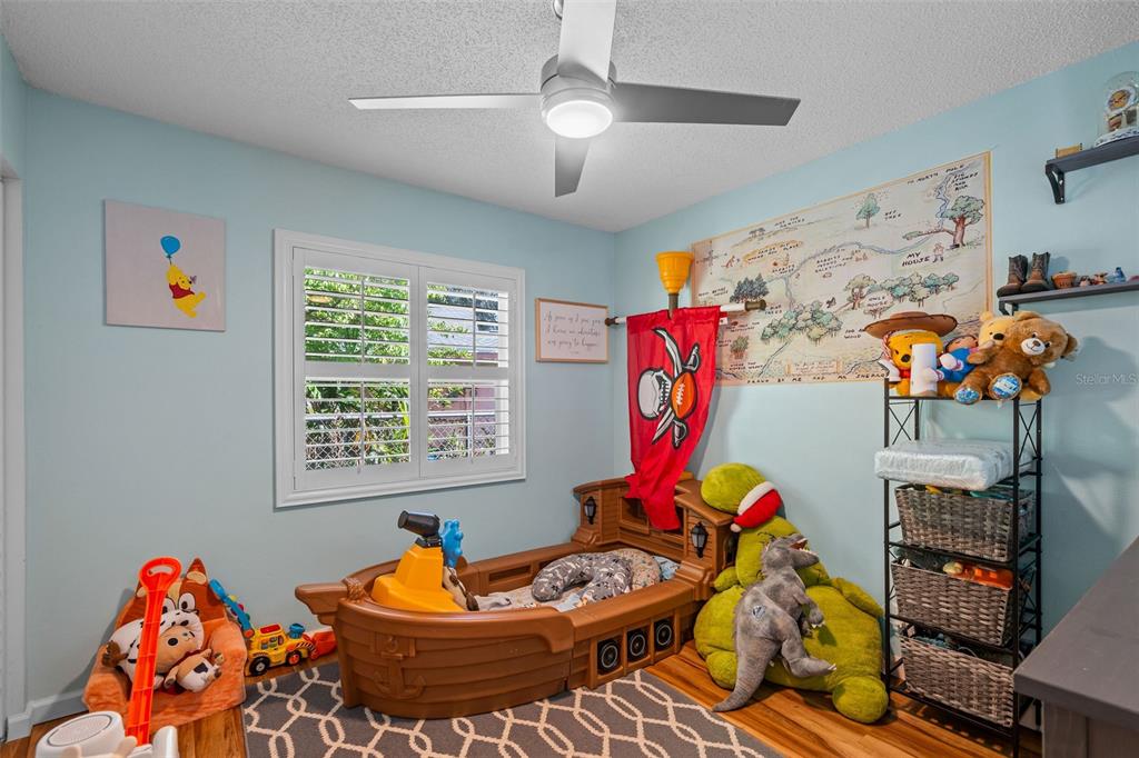 5558 57th Way Kenneth City, FL 33709 - Photo 15 of 33 a room with lots of white furniture and a chandelier