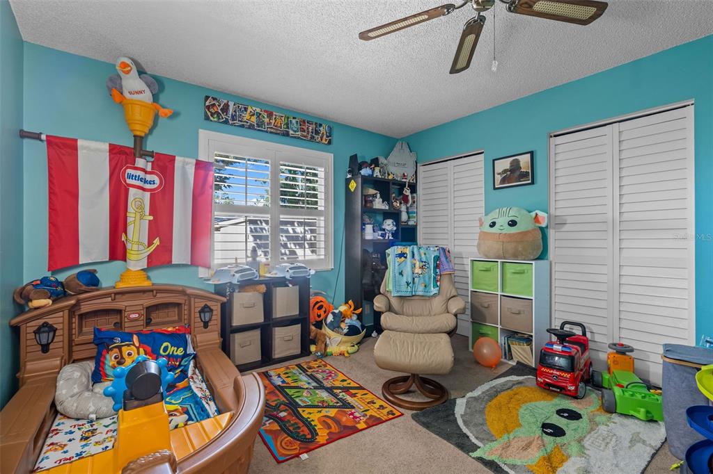 5558 57th Way Kenneth City, FL 33709 - Photo 18 of 33 a children room with furniture and toys