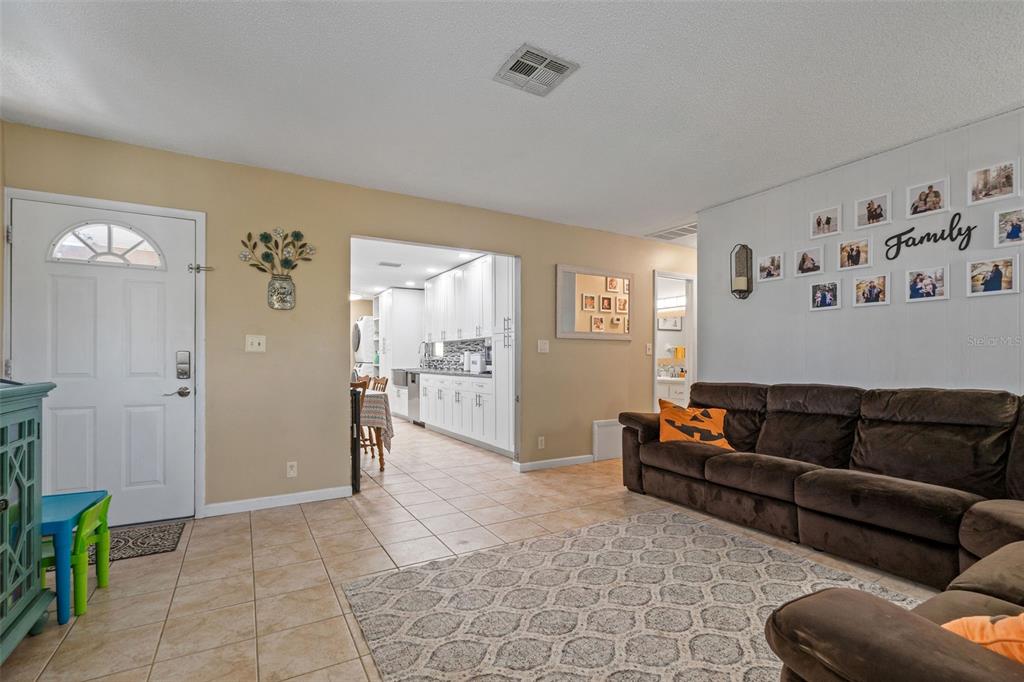 5558 57th Way Kenneth City, FL 33709 - Photo 2 of 33 a view of a livingroom with furniture and wooden floor