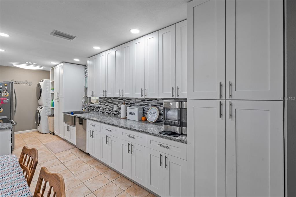 5558 57th Way Kenneth City, FL 33709 - Photo 8 of 33 a bathroom with a sink and a mirror