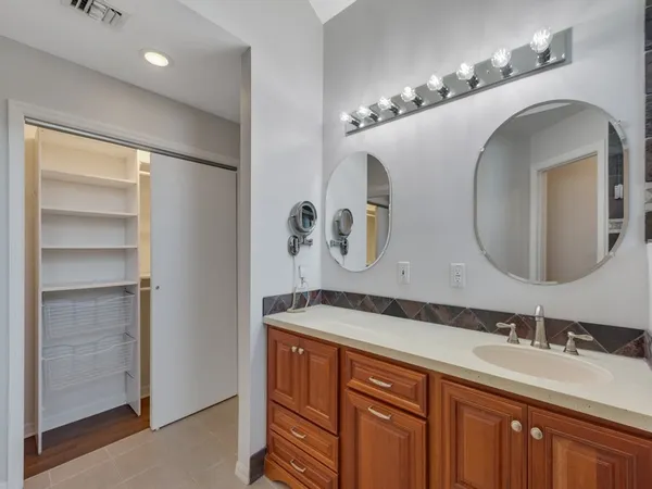 a bathroom with a double vanity sink and a mirror