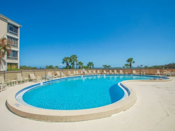 a view of a swimming pool and an outdoor seating