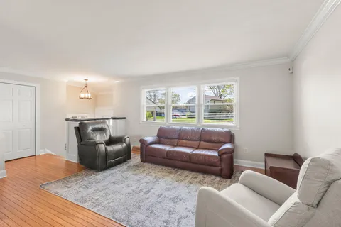 a living room with furniture and a clock