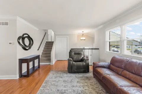 a living room with furniture and a clock