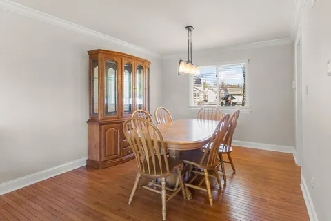 a view of a dining room with furniture and a chandelier