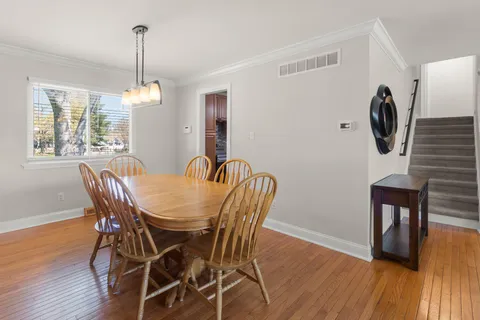 a kitchen with granite countertop a refrigerator a sink a stove and cabinets