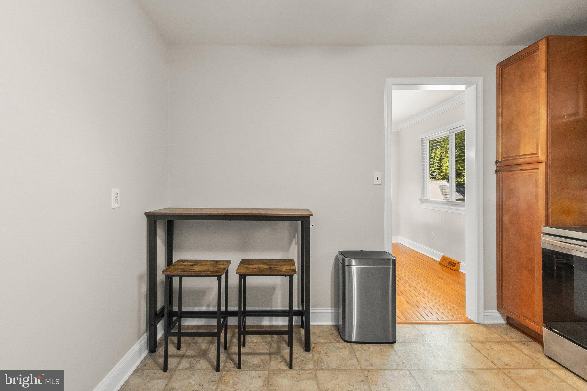 8 Slates End Newark, DE 19702 - Photo 27 of 54 a hallway with a table and a refrigerator