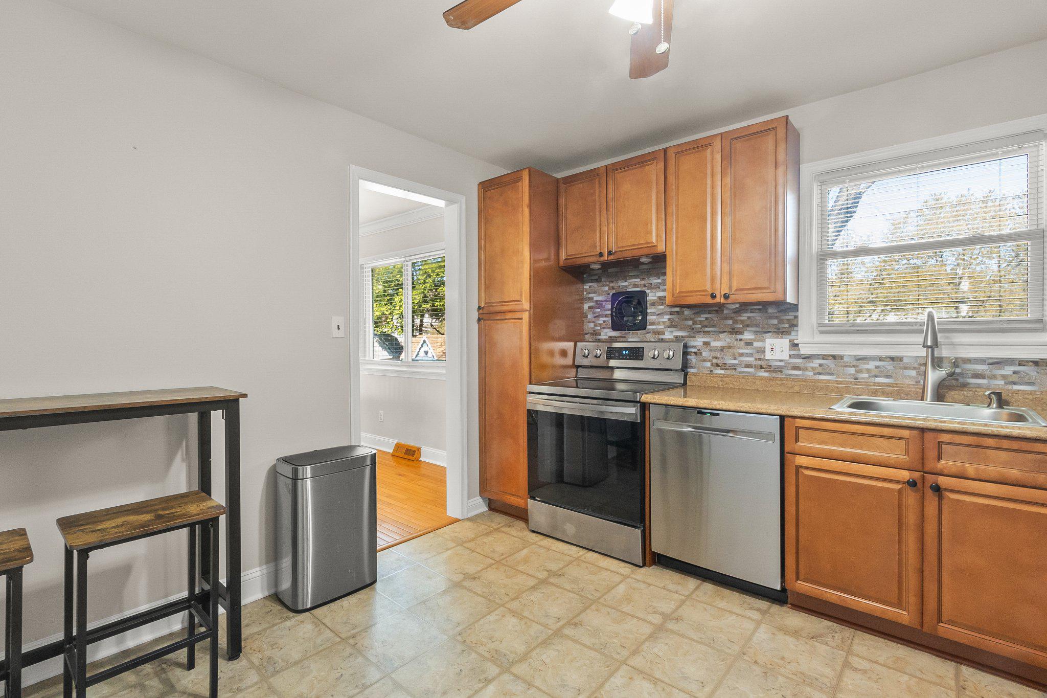 8 Slates End Newark, DE 19702 - Photo 28 of 54 a kitchen with stainless steel appliances granite countertop a stove a sink and a refrigerator
