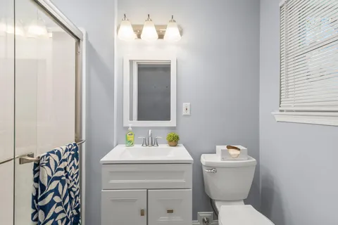 a bathroom with a double vanity sink mirror and double