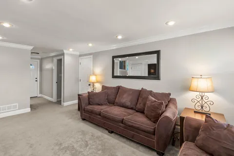 a room with furniture pool table and a flat screen tv