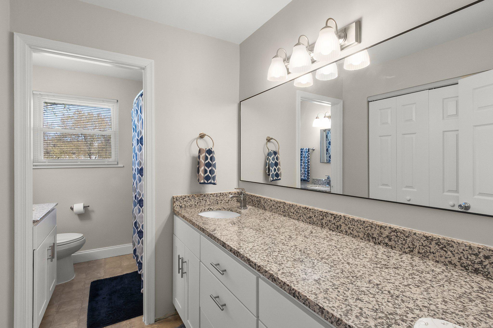 8 Slates End Newark, DE 19702 - Photo 43 of 54 a bathroom with a granite countertop sink a toilet and a mirror