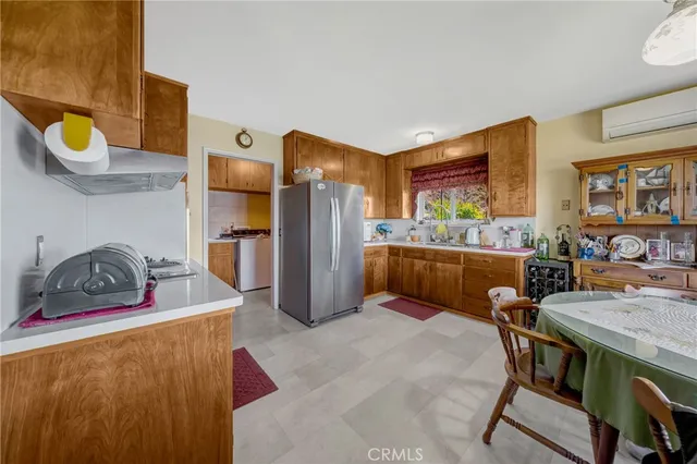 a kitchen with a refrigerator and a sink