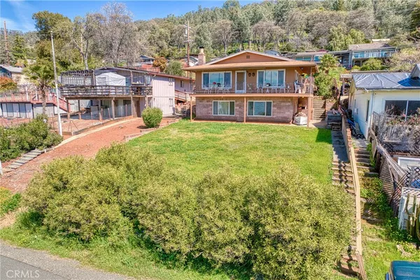 a view of a house with a yard and sitting area
