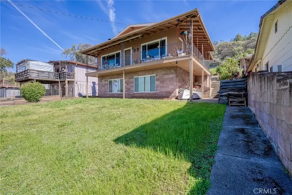 a view of a house with a small yard and a large window