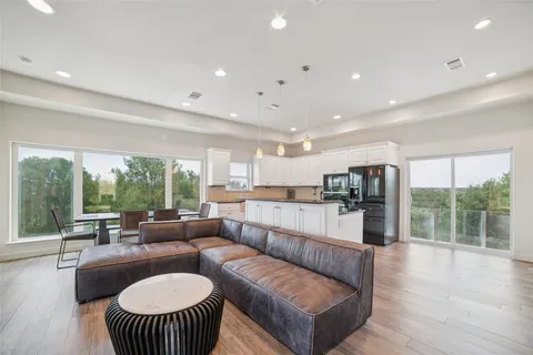a kitchen with a stove and a wooden floor
