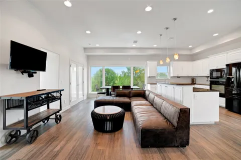 a living room with furniture a flat screen tv and a fireplace