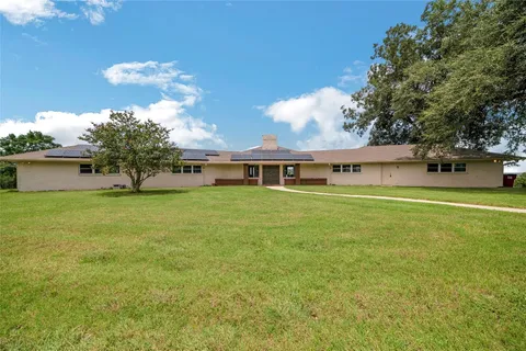 a view of a lake with couches in the patio