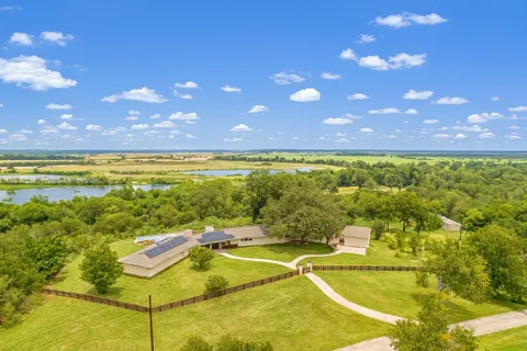 a view of a swimming pool with a patio and a yard