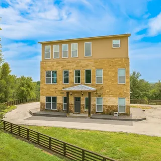 a view of a big building with big trees