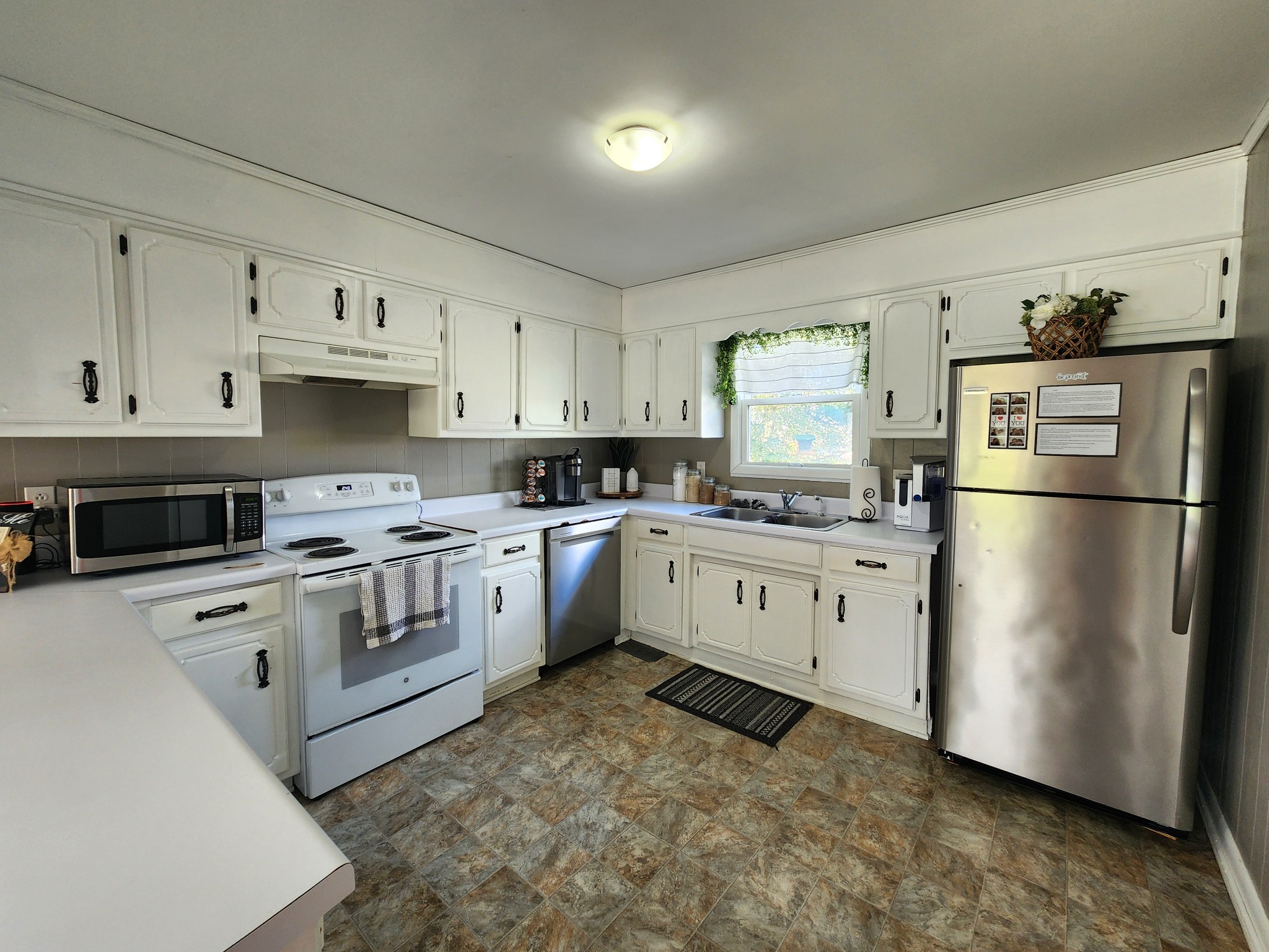 890 Tom Grissom Road Morrison, TN 37357 - Photo 6 of 17 a kitchen with white cabinets and white appliances
