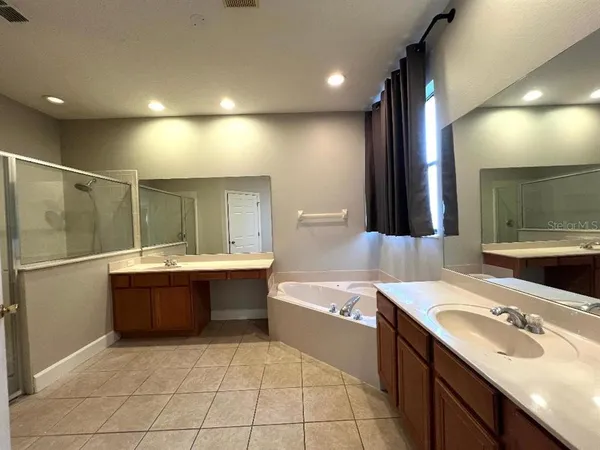 a view of a hallway with wooden floor and glass door