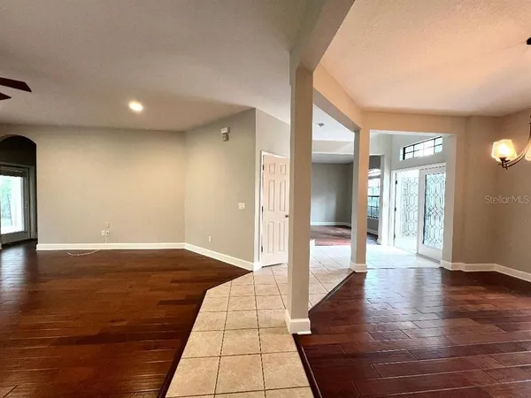 a view of an empty room and wooden floor