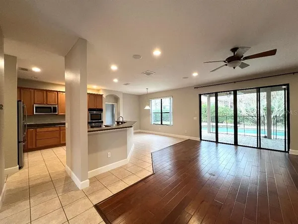 a open kitchen with stainless steel appliances granite countertop a refrigerator and a stove top oven