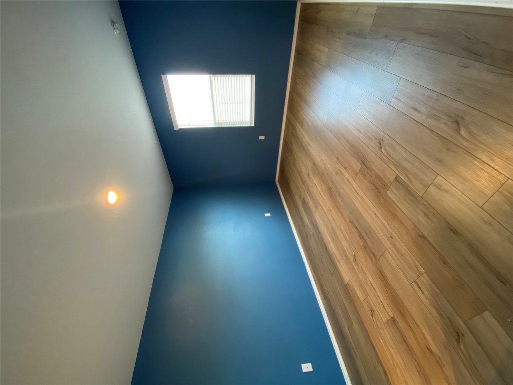 13704 Knights Branch Drive Elgin, TX 78621 - Photo 13 of 24 an empty room with wooden floor and windows
