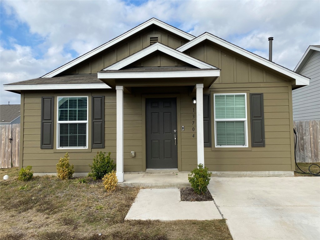 13704 Knights Branch Drive Elgin, TX 78621 - Photo 4 of 24 a front view of a house with a yard