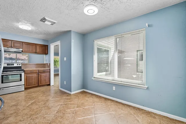 a kitchen with granite countertop stainless steel appliances a refrigerator sink and microwave