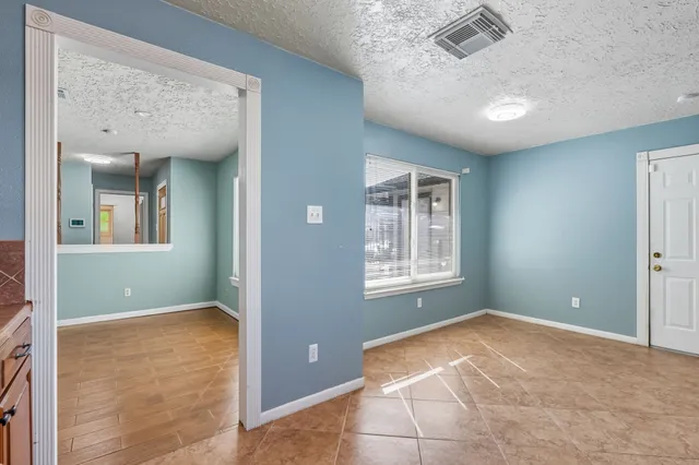 a metallic refrigerator freezer sitting in a kitchen