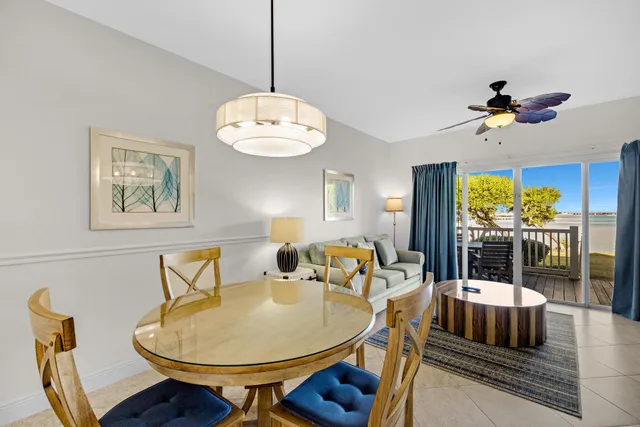 a dining room with furniture a chandelier and window