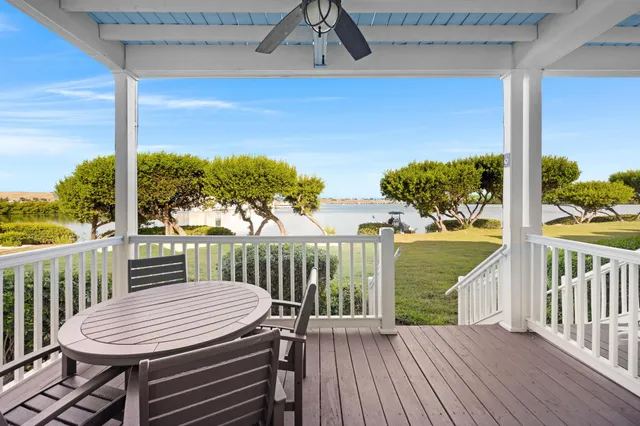 a view of a chairs and table in patio with wooden floor