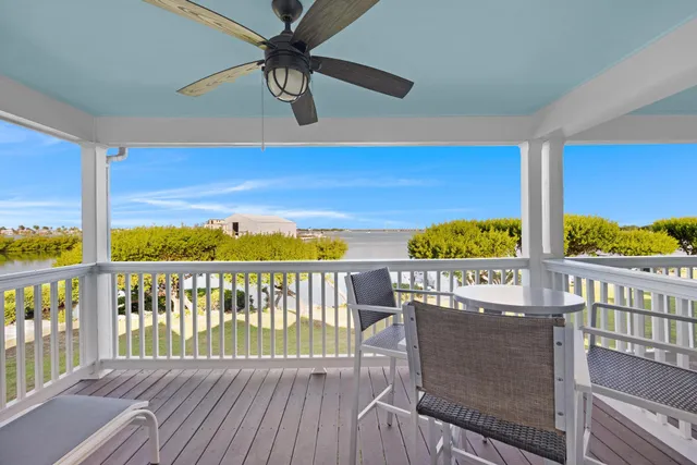 a view of a balcony dining area with wooden floor