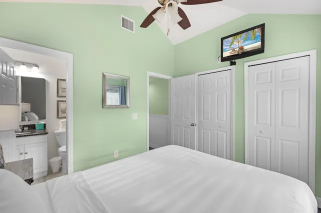 a bedroom with a bed and painting on the wall