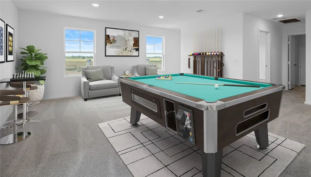 a room with pool table and windows