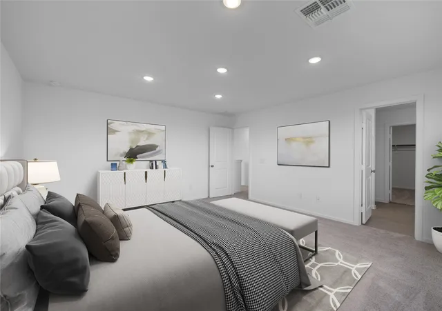 a bedroom with a bed and a painting on the wall