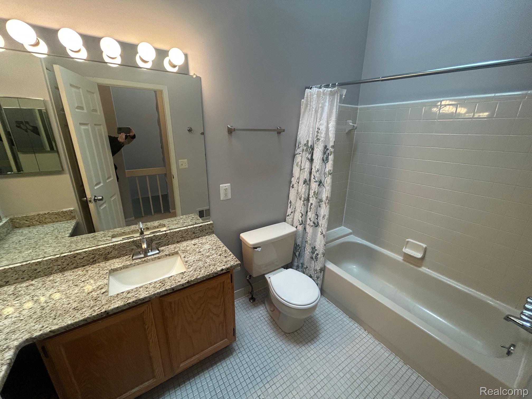31164 Country Way Farmington, MI 48331 - Photo 15 of 33 Full bathroom with vanity, shower / tub combo, and light tile patterned floors