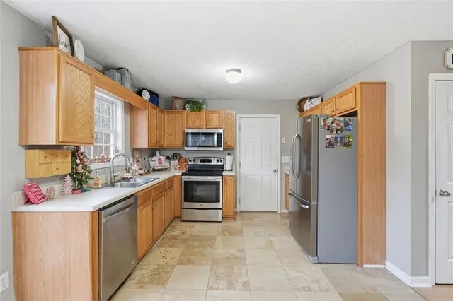 a kitchen with a sink cabinets and stainless steel appliances