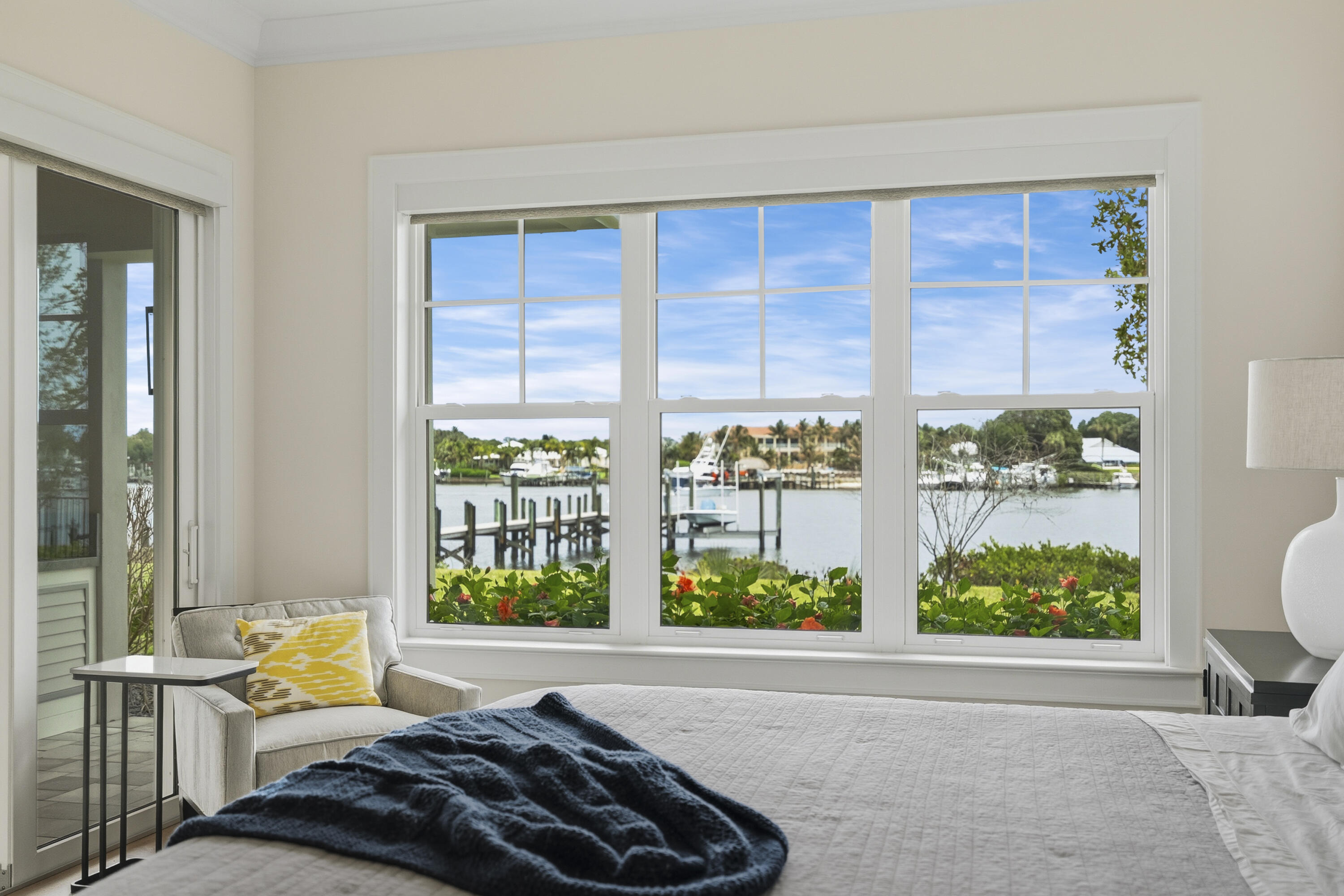 3973 Southeast Topsail Court Stuart, FL 34997 - Photo 15 of 38 a bed sitting in a bedroom next to a window
