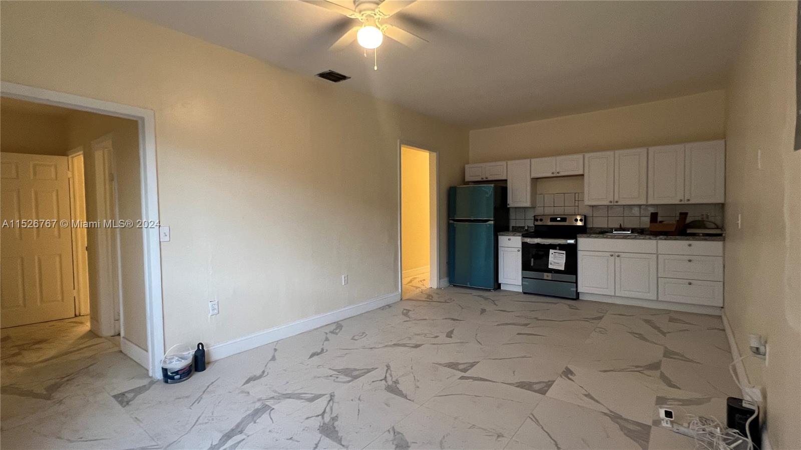 2168 Northwest 28th Street, Unit 1 Miami, FL 33142 - Photo 2 of 13 a view of a kitchen with microwave and cabinets