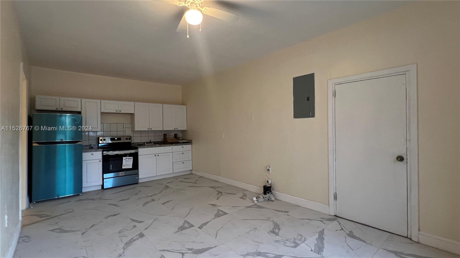 2168 Northwest 28th Street, Unit 1 Miami, FL 33142 - Photo 3 of 13 a large kitchen with a stove and a refrigerator