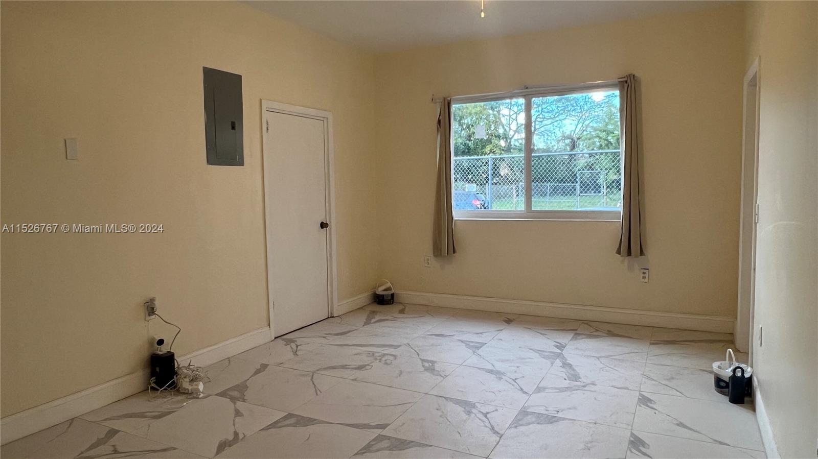2168 Northwest 28th Street, Unit 1 Miami, FL 33142 - Photo 4 of 13 a view of an empty room with a window