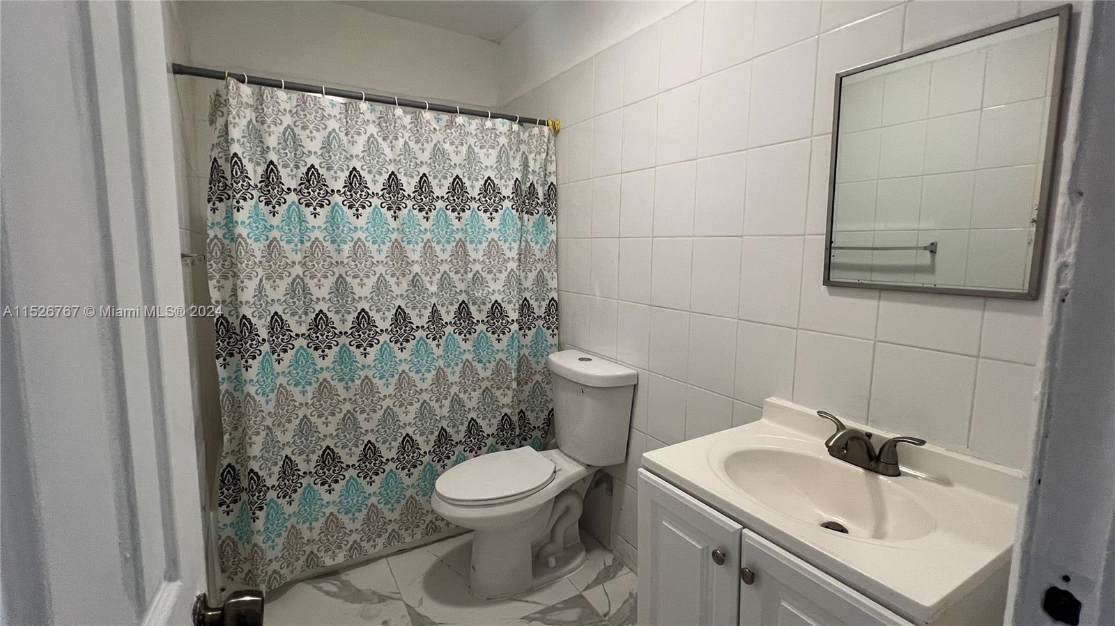 2168 Northwest 28th Street, Unit 1 Miami, FL 33142 - Photo 5 of 13 a bathroom with a sink toilet and shower