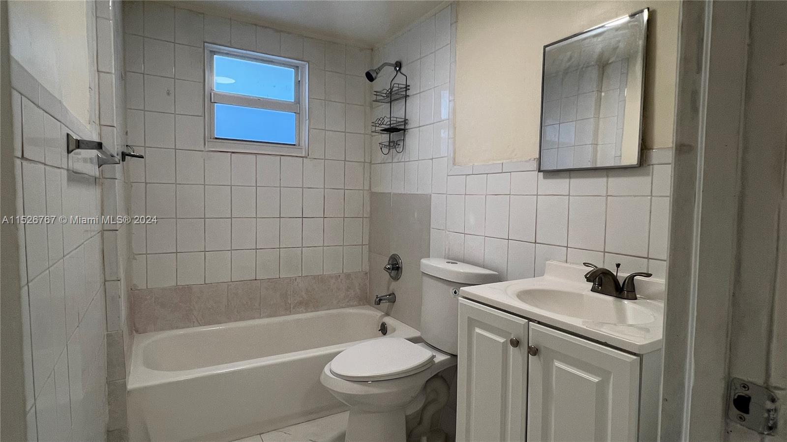 2168 Northwest 28th Street, Unit 1 Miami, FL 33142 - Photo 6 of 13 a bathroom with a sink a toilet and shower