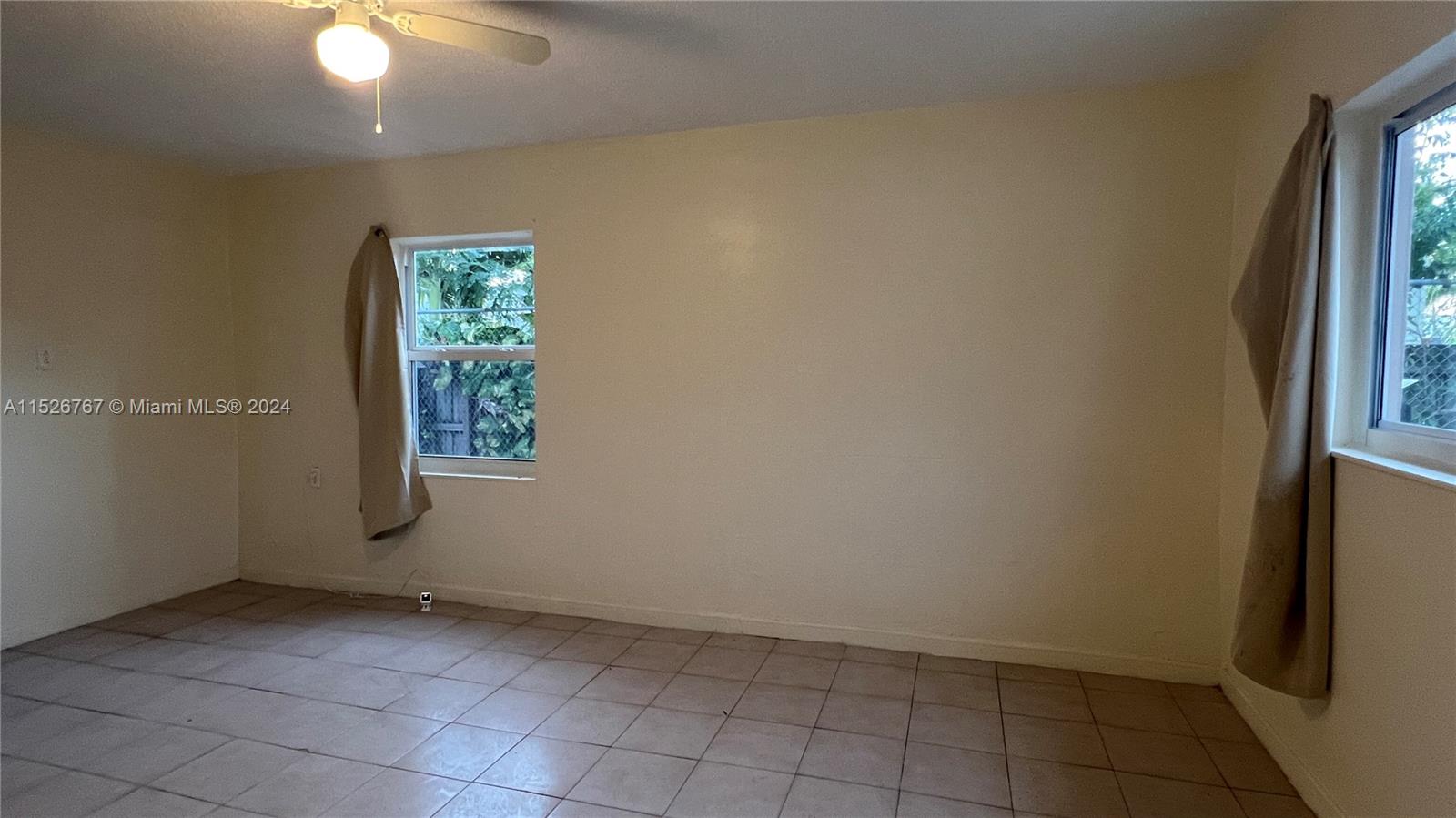 2168 Northwest 28th Street, Unit 1 Miami, FL 33142 - Photo 9 of 13 an empty room with windows