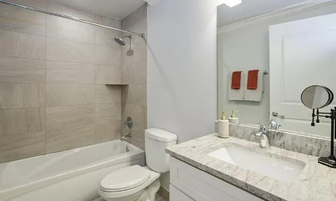 1050 West Monroe Street, Unit 401 Chicago, IL 60607 - Photo 11 of 17 a bathroom with a granite countertop sink toilet mirror and shower