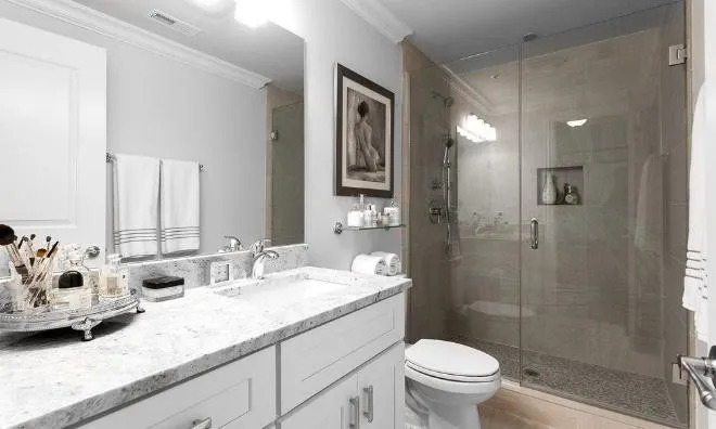 1050 West Monroe Street, Unit 401 Chicago, IL 60607 - Photo 13 of 17 a bathroom with a granite countertop sink a toilet and shower