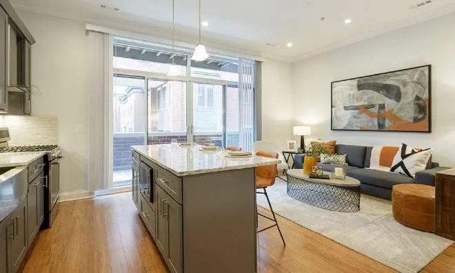 1050 West Monroe Street, Unit 401 Chicago, IL 60607 - Photo 16 of 17 a spacious kitchen with stainless steel appliances granite countertop a lot of counter space and a wooden floor