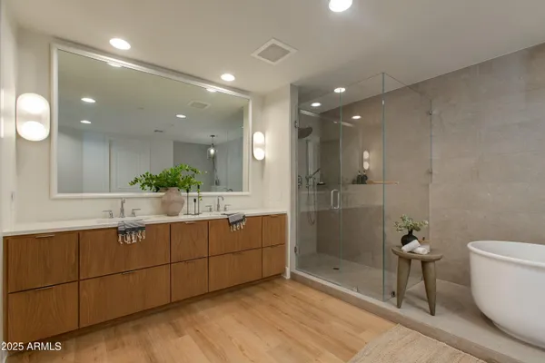 a bathroom with a granite countertop sink a toilet a mirror and shower